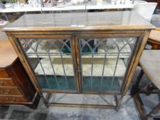 Circa 1930's oak china display cabinet enclosed by two Gothic-style leaded glass panelled doors,
