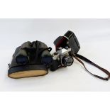 Praktica SLR camera in leather case, a pair of early 20th century binoculars retailed by Shoolbred &