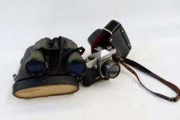 Praktica SLR camera in leather case, a pair of early 20th century binoculars retailed by Shoolbred &