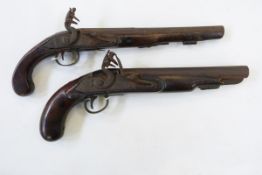 Two flintlock pistols with wooden stock and metal mounts