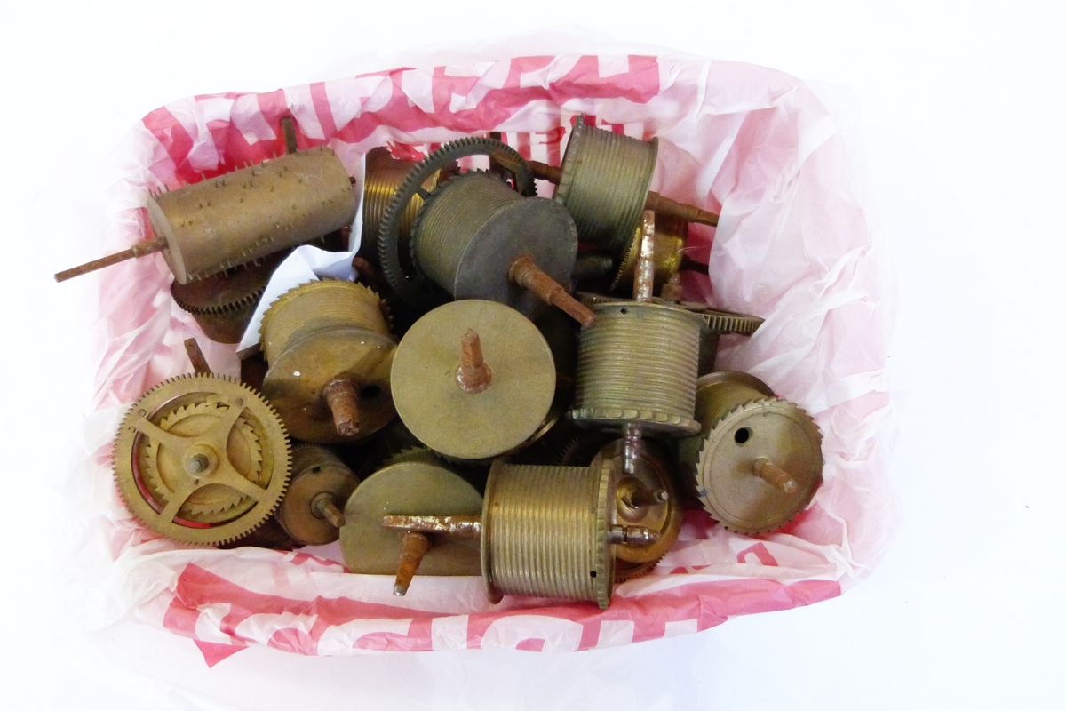 Collection of assorted clock parts including a box of pendulum parts, a box of cogs, fusee parts,