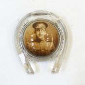 Late 19th/early 20th century pressed glass paperweight in the form of a horseshoe with a portrait