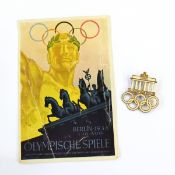 German enamelled gilt metal badge commemorating the 1936 Berlin Olympics, modelled with the five