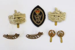 Two Gloucestershire Regiment cap badges surmounted by the Egypt Sphinx and various other regimental