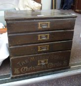 The Milton Series Christmas Cards"" four-drawer table top chest having four graduated drawers and