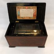 Swiss musical box playing eight airs, with coloured tune card,