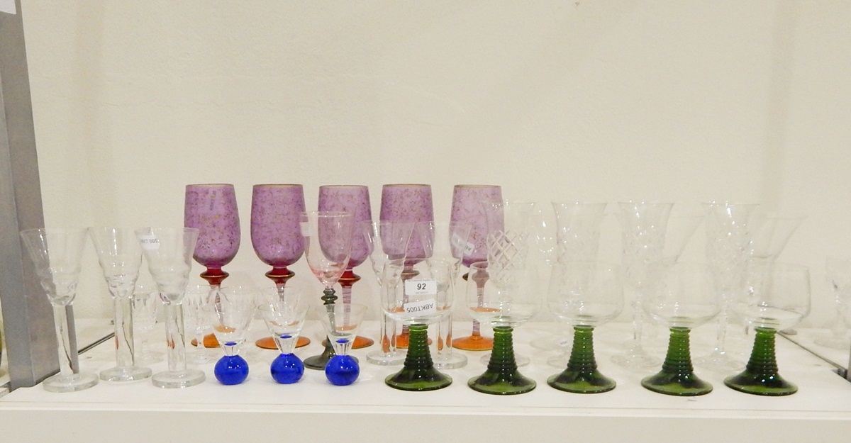 Quantity of drinking glasses including a set of five purple wine glasses with gilt decoration,