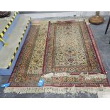 Persian wool rug, the cream ground with stylised foliate decoration, red and green border,