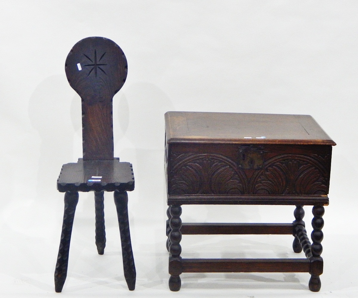 Oak bible box with carved front, on turned stand, 60cm diameter and an oak spinning chair,