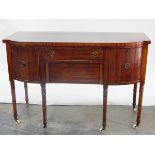 19th century mahogany bowfront sideboard with central frieze drawer and deep apron drawer below,