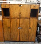 20th century figured walnut cocktail/entertainment cabinet having central cocktail cabinet with