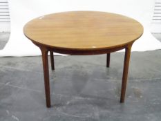 Teak circular extending dining table, by McIntosh,