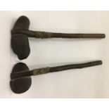 Pair Oceanic stone-head axe-type clubs bound to a wooden shaft with leather and reeds,