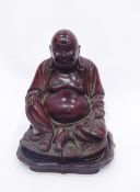 Early 20th century large carved hardwood figure of a seated laughing Buddha with bone teeth,