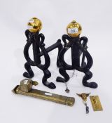 Pair of Art Nouveau design wrought iron fire dogs of heart-shaped design surmounted by brass knops,
