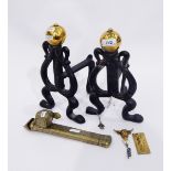 Pair of Art Nouveau design wrought iron fire dogs of heart-shaped design surmounted by brass knops,