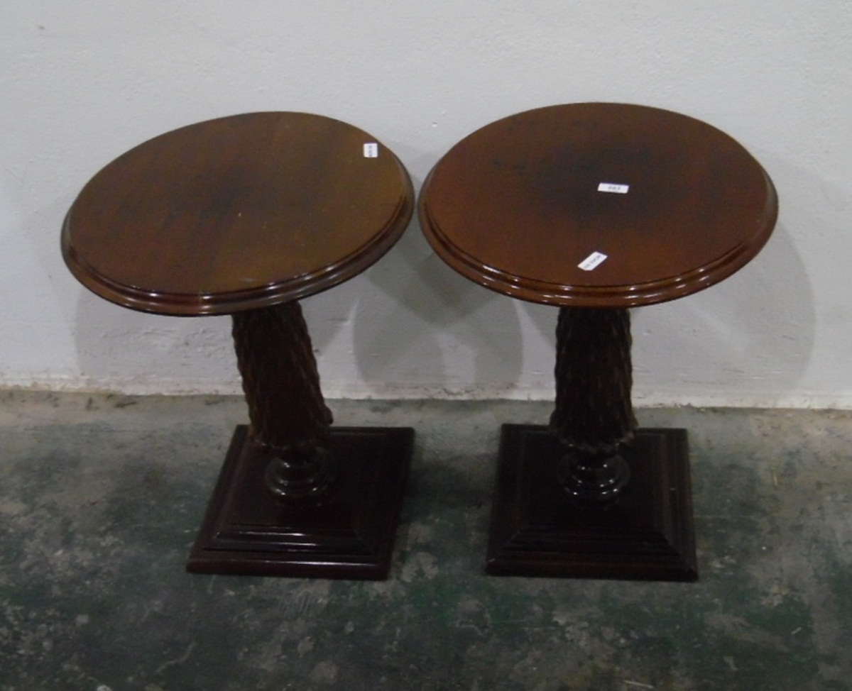 Pair of mahogany circular lamp tables on carved pedestals, with square moulded plinth bases,