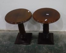 Pair of mahogany circular lamp tables on carved pedestals, with square moulded plinth bases,