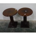 Pair of mahogany circular lamp tables on carved pedestals, with square moulded plinth bases,