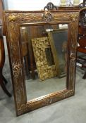 Rectangular wall mirror within a contemporary frame, with stylised floral decoration,