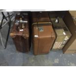 Three various travelling cases with shipping labels