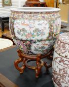 Chinoiserie-style ceramic garden planter on a carved wooden stand,