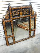 Carved wood overmantel mirror with carving of urn and flowers over a bevelled mirror,