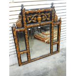 Carved wood overmantel mirror with carving of urn and flowers over a bevelled mirror,