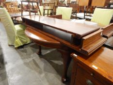 Georgian-style mahogany wind-out dining table with rounded ends and moulded edged top,