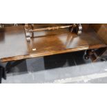 Dark stained oak rectangular magazine/coffee table with moulded top and on turned supports,
