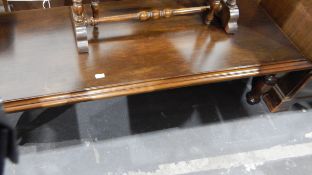 Dark stained oak rectangular magazine/coffee table with moulded top and on turned supports,