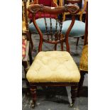 Late Victorian mahogany-framed nursing chair with turned spindle back, carved and shaped crest rail,
