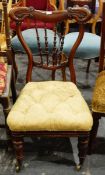 Late Victorian mahogany-framed nursing chair with turned spindle back, carved and shaped crest rail,