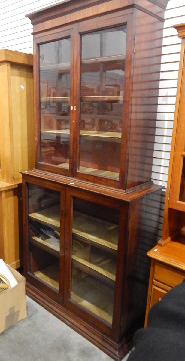 19th century cross-banded mahogany bookcase/display cabinet enclosed by two glass panelled doors