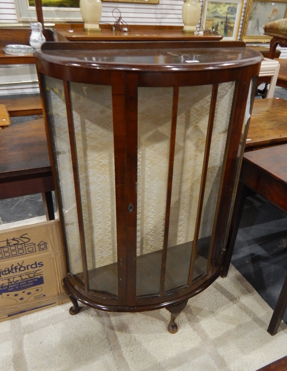 Mid 20th century demi-lune dark stained display cabinet on squat cabriole supports,