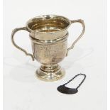 Silver two-handled trophy, Birmingham 1935 and a modern silver wine label for whisky,