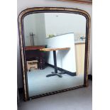 Overmantel mirror of rectangular form with arched top, the frame with ebonised and gilt decoration,