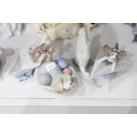 Lladro model of a puppy in a paper boat, another on a paper aeroplane,