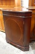 Mahogany bowfront corner cupboard raised on bracket feet,