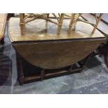 Old oak oval-top gateleg table with moulded edge, on turned baluster supports,