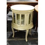 Modern cream painted circular display cabinet with glass panelled doors, on cabriole legs,
