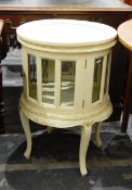 Modern cream painted circular display cabinet with glass panelled doors, on cabriole legs,