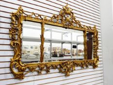 Carved giltwood overmantel wall mirror, rectangular and in three sections,