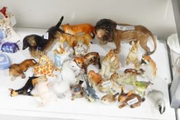 Melbaware model lion, 14cm high, a model dachshund (repaired), a Beswick model fox (repaired),