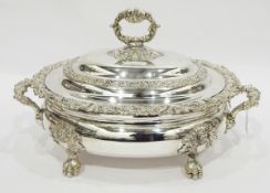 Victorian silver plate two-handled soup tureen, scroll relief decorated, on claw feet,