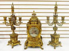 Brass clock garniture comprising a clock with circular engraved steel dial with Roman numerals,