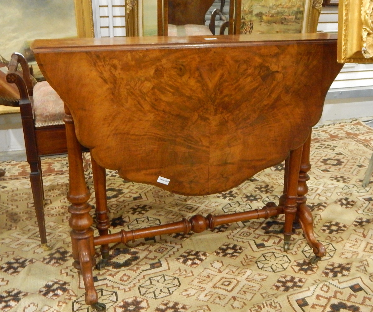 Figured walnut Sutherland table with shaped moulded top, on turned standard supports, shaped legs,