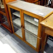 Two dwarf cabinets enclosed by glass panelled doors (2)