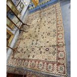 Large Middle Eastern rug, the cream ground with brown geometric border,