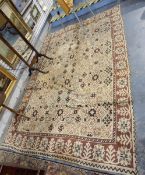 Large Middle Eastern rug, the cream ground with brown geometric border,
